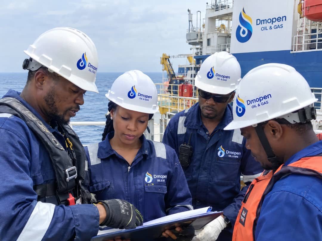 Dmopen team members reviewing documents on a vessel deck